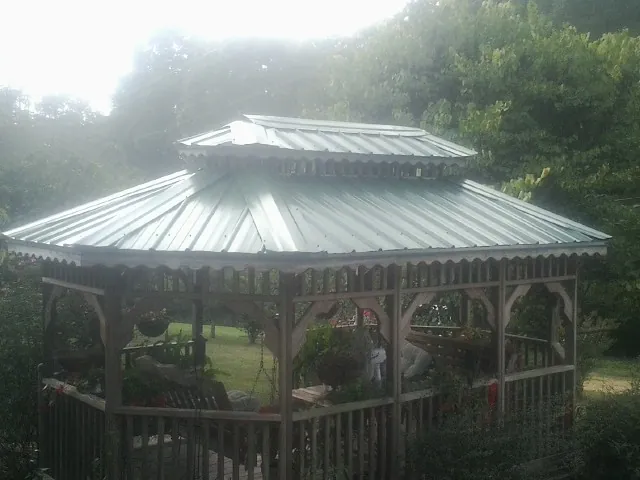 Two tier green metal roof on a garden gazebo in East Templeton